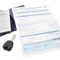 Document de demande de carte grise utilitaire, avec une clé de voiture posée dessus.