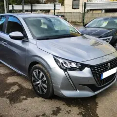 Peugeot 208 grise, prête pour sa révision. Le tarif de la révision Peugeot 208 est affiché sur le pare-brise.