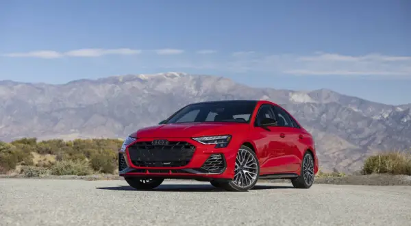 Une Audi S3 rouge vif, prête à libérer ses chevaux sur une route de montagne désertique.